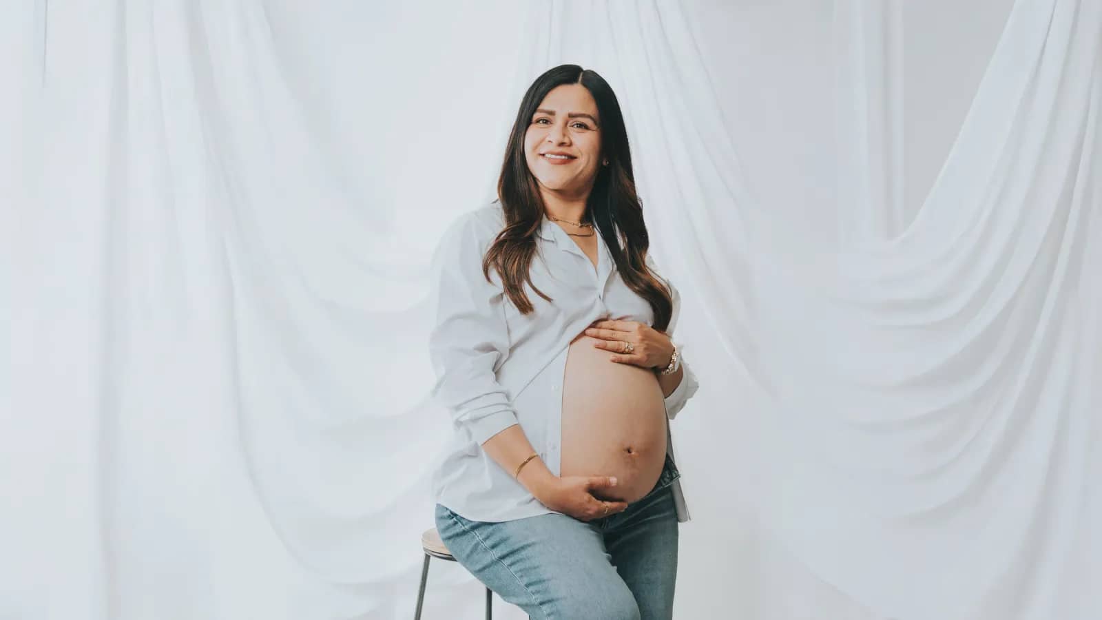 Mujer sonriendo con cortinas blancas